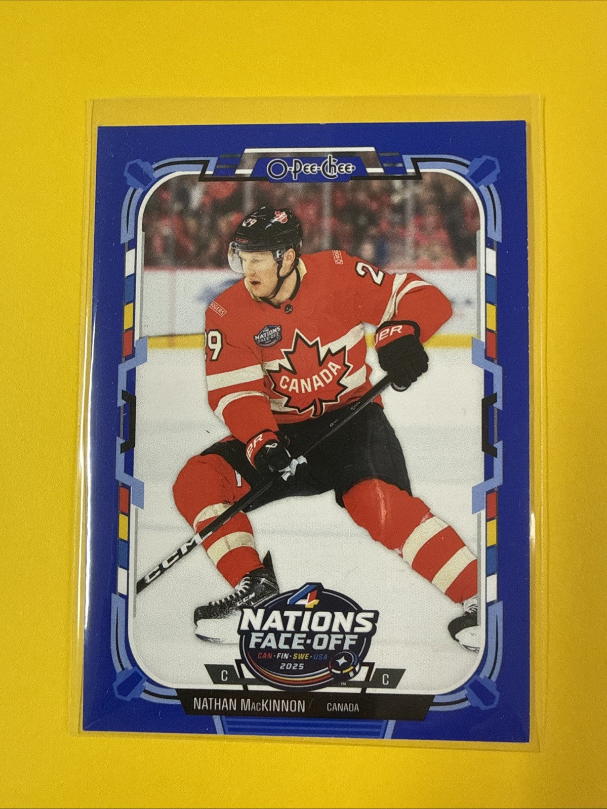 2025-26 O-Pee-Chee Nathan MacKinnon 4 Nations Face Off Blue Border SP Canada - front